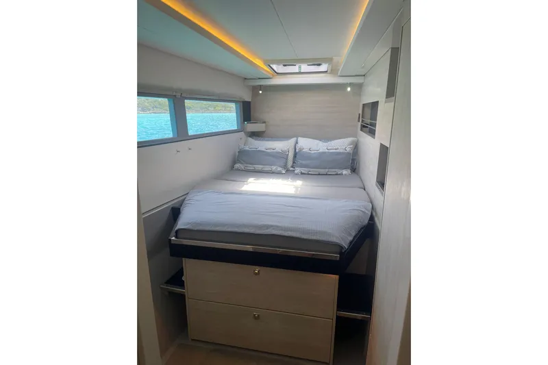  Yacht Photos Pics Luxurious cabin interior of 2019 Leopard 45 yacht with cozy bed and scenic window view.