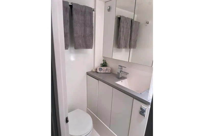  Yacht Photos Pics Modern bathroom in 2019 Leopard 45 yacht with sleek fixtures and gray towels.