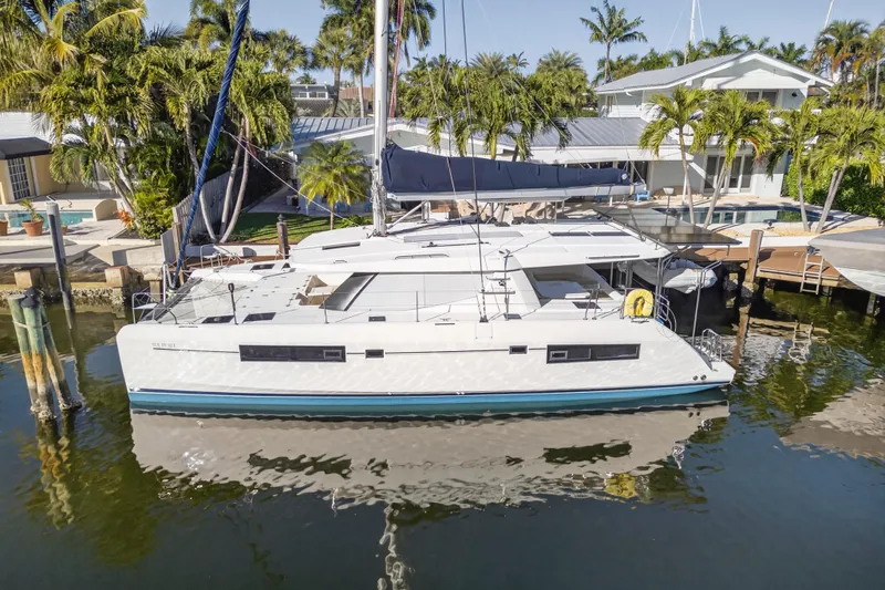  Yacht Photos Pics 2019 Leopard 45 catamaran docked in a tropical marina setting.
