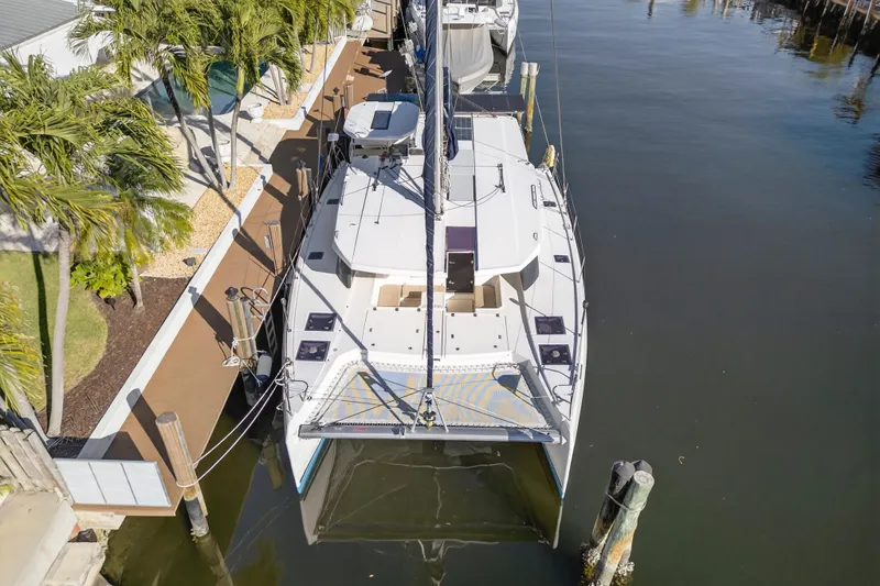 Yacht Photos Pics Aerial view of 2019 Leopard 45 catamaran docked by palm trees.