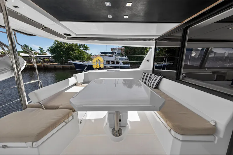  Yacht Photos Pics Spacious outdoor seating area on a 2019 Leopard 45 yacht, featuring a sleek table and cushions.