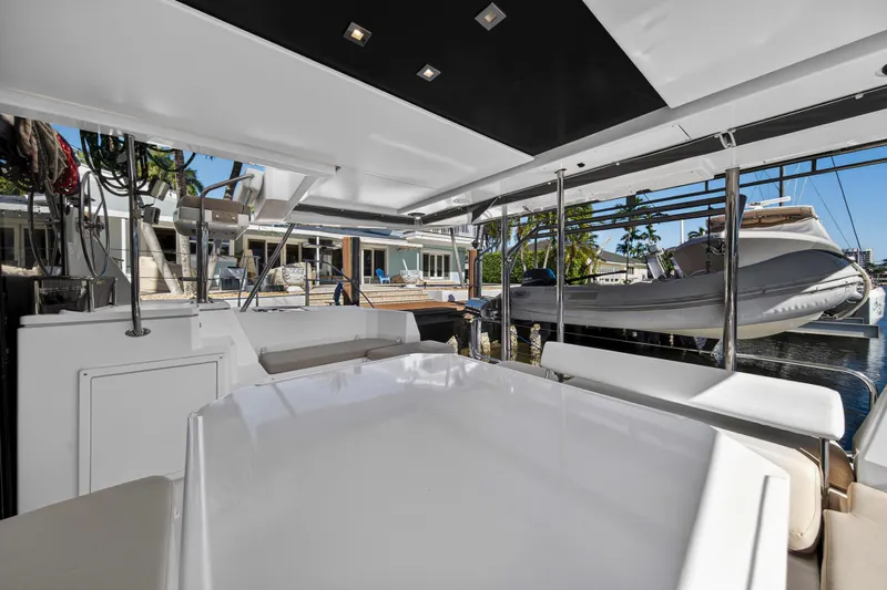  Yacht Photos Pics 2019 Leopard 45 yacht interior with modern seating and docked boat view.