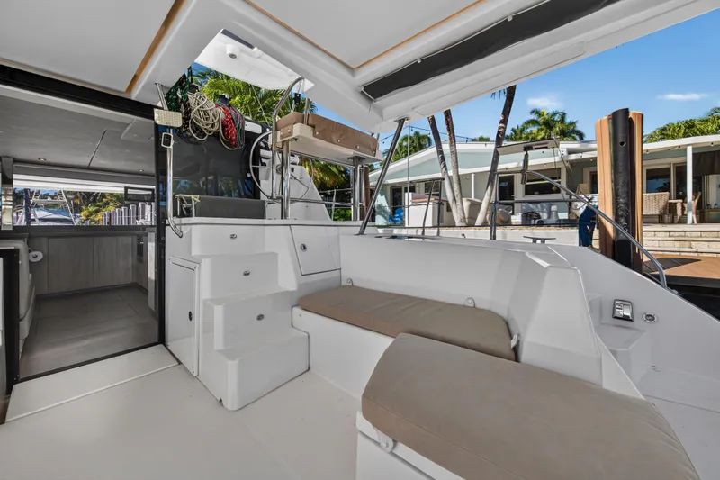  Yacht Photos Pics 2019 Leopard 45 yacht interior with seating, steps, and dockside view.
