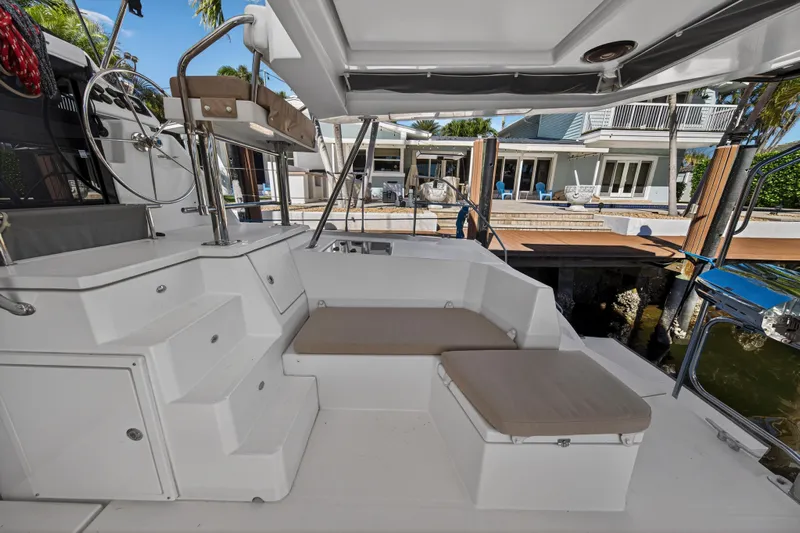  Yacht Photos Pics 2019 Leopard 45 yacht cockpit with seating, steering wheel, and dock view.