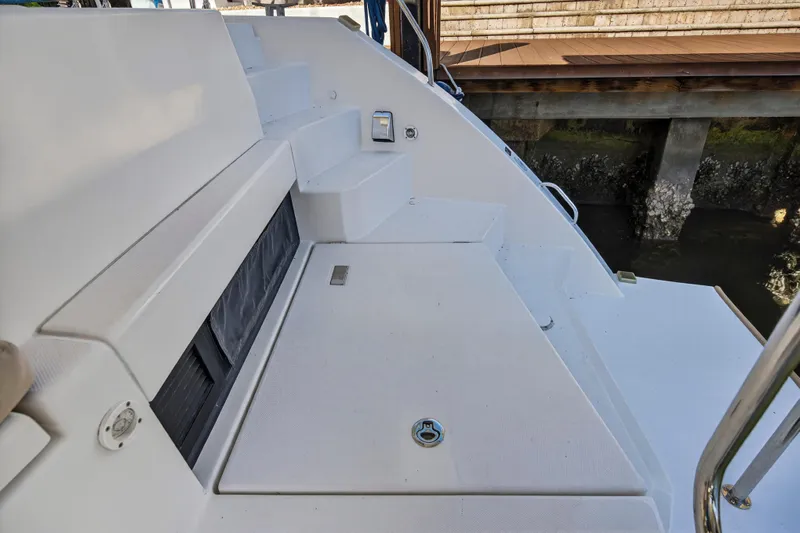  Yacht Photos Pics Leopard 45 catamaran deck, 2019 model, featuring steps and seating area by the dock.