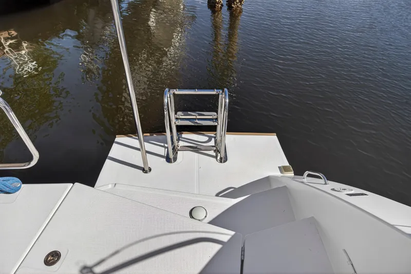  Yacht Photos Pics Stern view of 2019 Leopard 45 catamaran with swim ladder and water reflection.