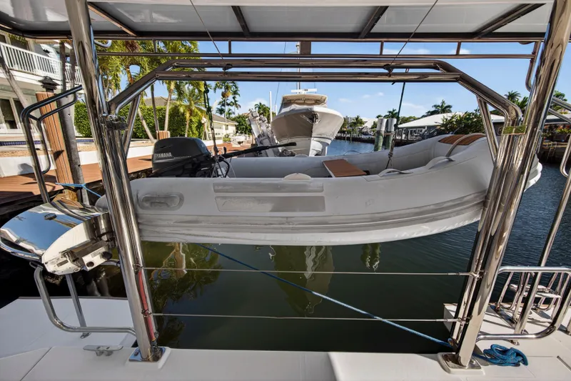  Yacht Photos Pics 2019 Leopard 45 yacht with dinghy and Yamaha motor in a marina setting.