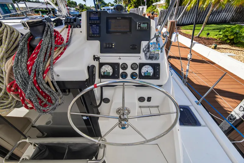  Yacht Photos Pics 2019 Leopard 45 yacht helm with steering wheel, navigation instruments, and colorful ropes.