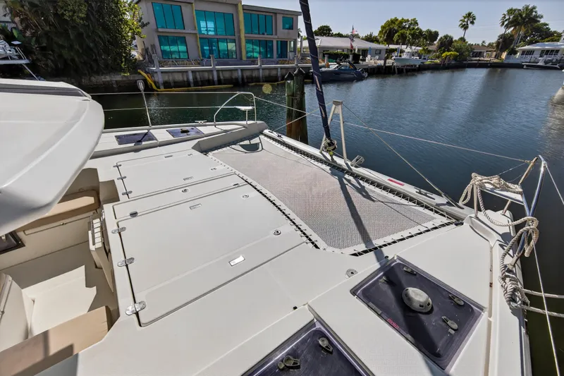  Yacht Photos Pics 2019 Leopard 45 catamaran docked, featuring spacious deck and netting area.