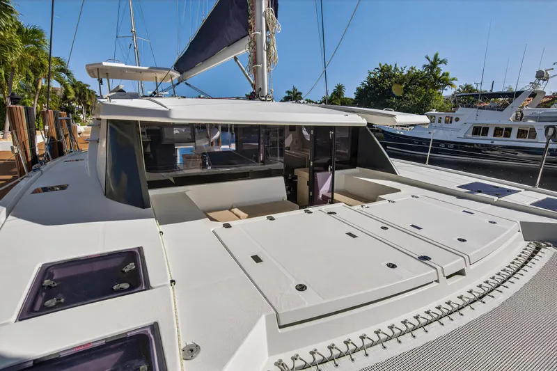  Yacht Photos Pics 2019 Leopard 45 catamaran docked, showcasing spacious deck and modern design.