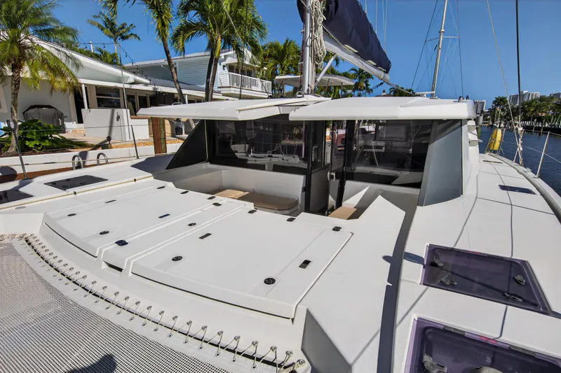  Yacht Photos Pics 2019 Leopard 45 catamaran docked, featuring spacious deck and modern design.