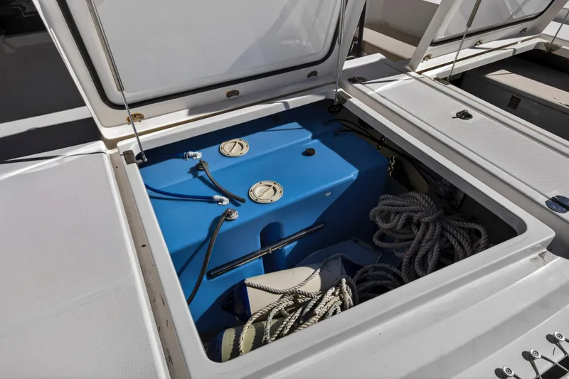  Yacht Photos Pics Open storage compartment on 2019 Leopard 45 yacht with ropes and blue tank.