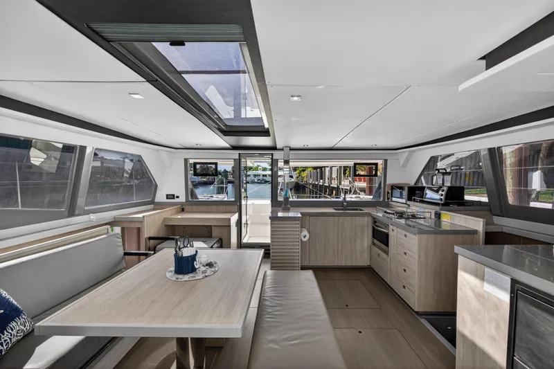  Yacht Photos Pics Luxurious interior of a 2019 Leopard 45 catamaran with modern kitchen and dining area.