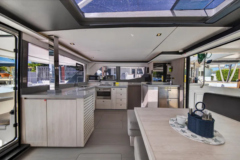  Yacht Photos Pics Luxurious interior of 2019 Leopard 45 yacht with modern kitchen and dining area.