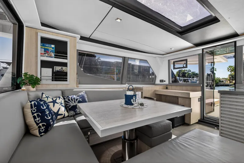  Yacht Photos Pics Luxurious interior of 2019 Leopard 45 yacht with modern dining area and nautical decor.