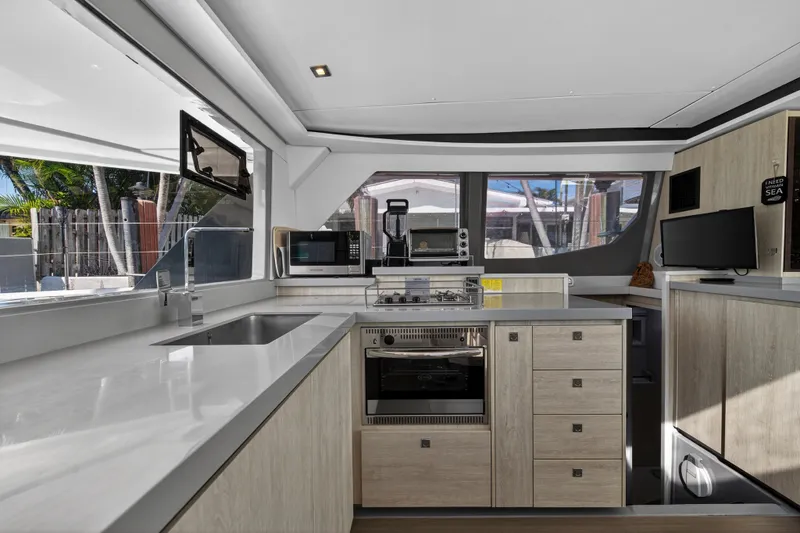  Yacht Photos Pics Modern kitchen interior on a 2019 Leopard 45 yacht, featuring sleek countertops and appliances.