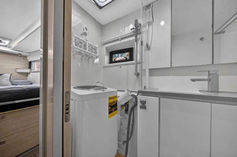  Yacht Photos Pics Modern Leopard 45 yacht interior with bedroom and bathroom, featuring sleek design and compact amenities.