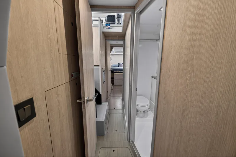  Yacht Photos Pics Interior of 2019 Leopard 45 yacht, featuring a modern bathroom and hallway with wooden finishes.