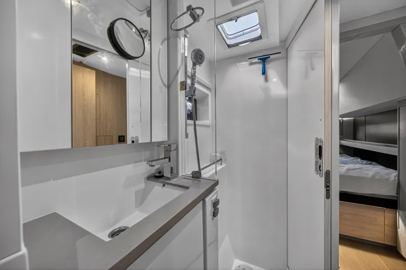  Yacht Photos Pics Modern bathroom interior on a 2019 Leopard 45 yacht, featuring sleek fixtures and a shower.
