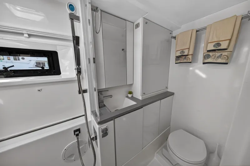  Yacht Photos Pics Modern bathroom in a 2019 Leopard 45 yacht, featuring sleek design and nautical decor.