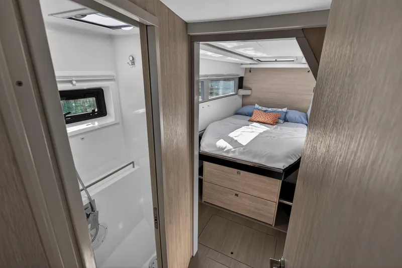 Yacht Photos Pics 2019 Leopard 45 yacht interior with cozy bedroom and adjacent bathroom.
