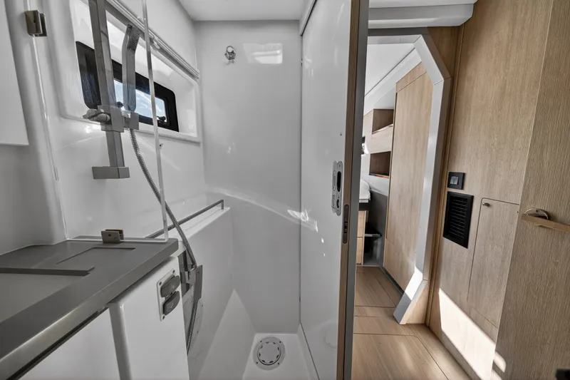  Yacht Photos Pics Modern bathroom interior on 2019 Leopard 45 yacht, featuring sleek design and wooden accents.