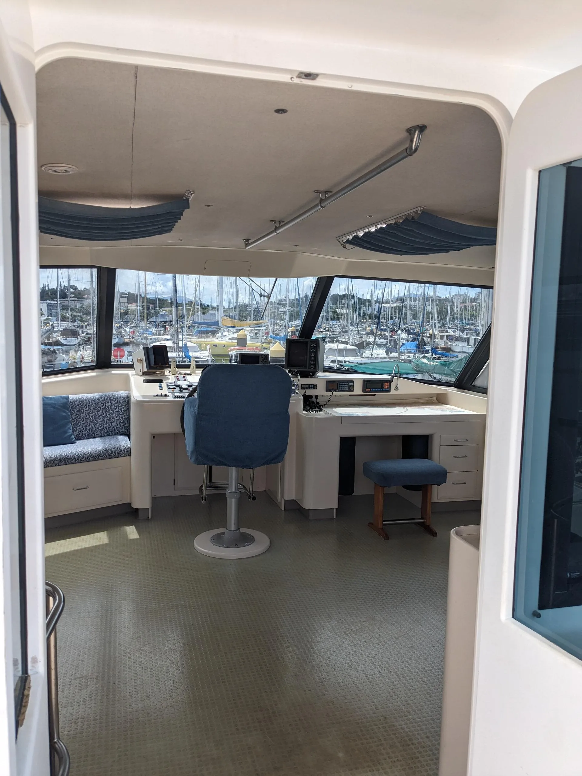 Interior of 1991 Mitchell Powercat 58 yacht with helm and seating area.