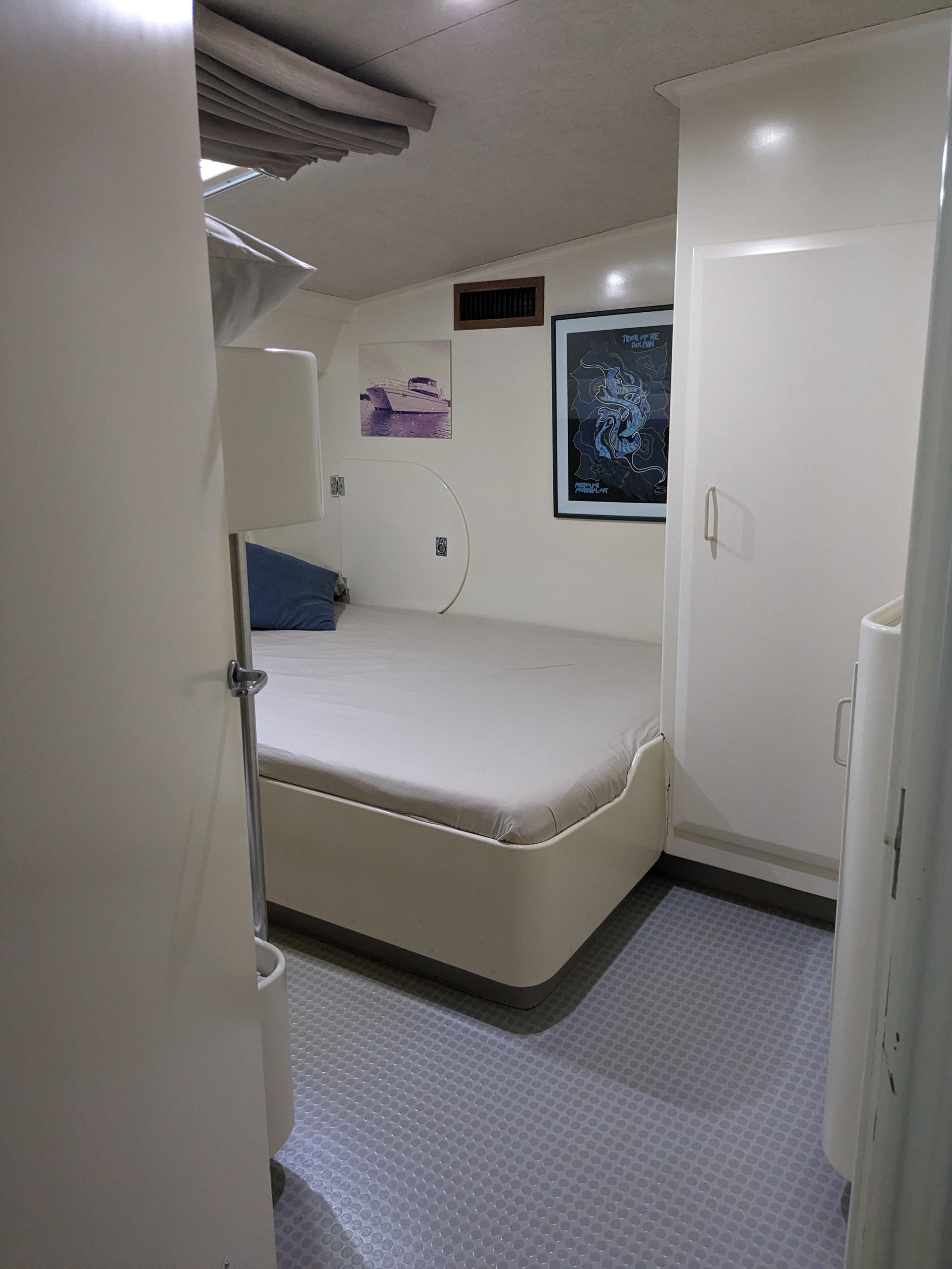 Cozy bedroom interior of 1991 Mitchell Powercat 58 yacht with modern decor and soft lighting.