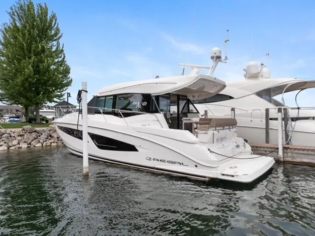 Horizen Yacht Photos Pics 2017 Regal 42 Grande Coupe yacht docked in a marina, side view.