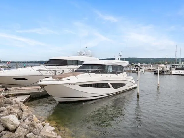 Horizen Yacht Photos Pics 2017 Regal 42 Grande Coupe yacht docked at marina under clear blue sky.