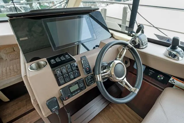 Horizen Yacht Photos Pics Helm of 2017 Regal 42 Grande Coupe with steering wheel and control panel.