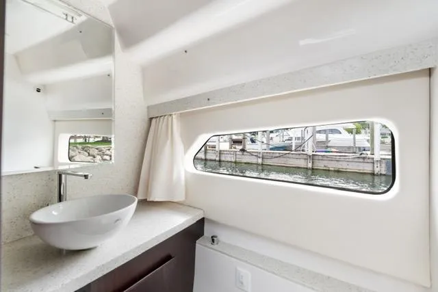 Horizen Yacht Photos Pics Luxurious bathroom interior of 2017 Regal 42 Grande Coupe yacht with modern sink and window view.