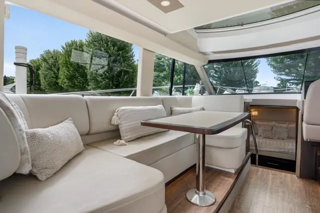 Horizen Yacht Photos Pics Luxurious interior of 2017 Regal 42 Grande Coupe yacht with plush seating and dining area.