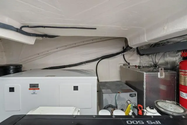 Horizen Yacht Photos Pics Engine room of 2017 Regal 42 Grande Coupe with generator and fire extinguisher.