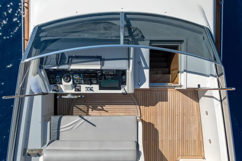  Yacht Photos Pics Aerial view of 1999 Falcon Yachts 86 cockpit with wooden deck and navigation controls.