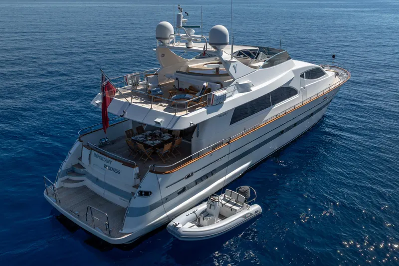  Yacht Photos Pics Luxurious 1999 Falcon Yachts 86 on serene blue ocean waters.