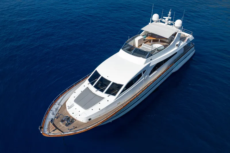  Yacht Photos Pics Luxurious 1999 Falcon Yachts 86 cruising on deep blue ocean waters.