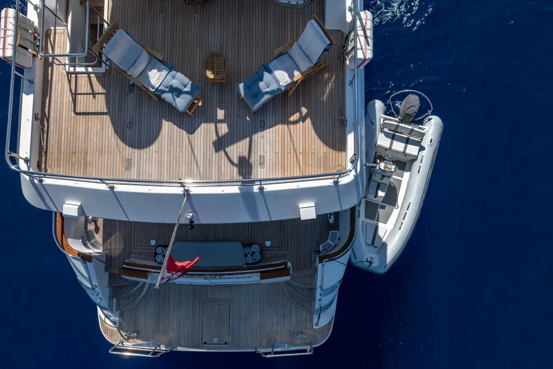  Yacht Photos Pics Aerial view of 1999 Falcon Yachts 86 with deck chairs and tender boat.