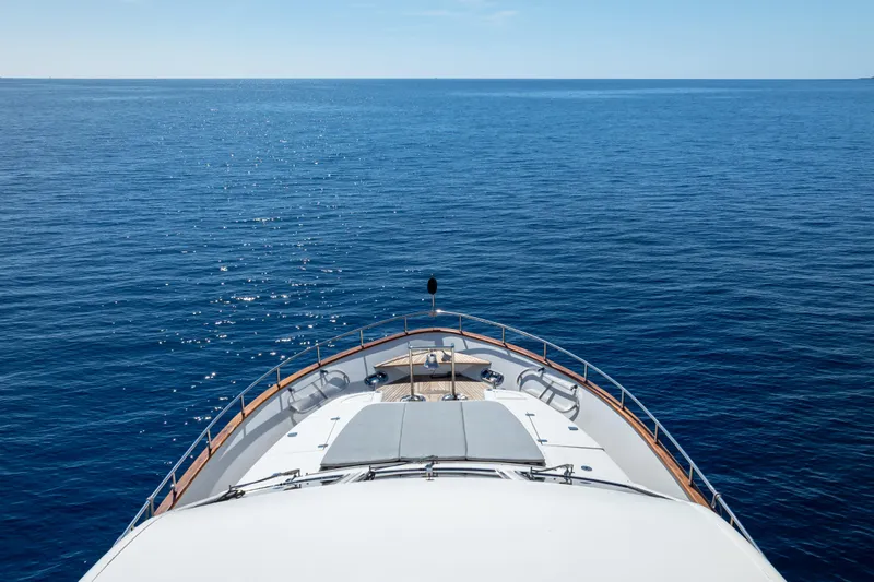  Yacht Photos Pics Bow view of 1999 Falcon Yachts 86 on open sea under clear sky.