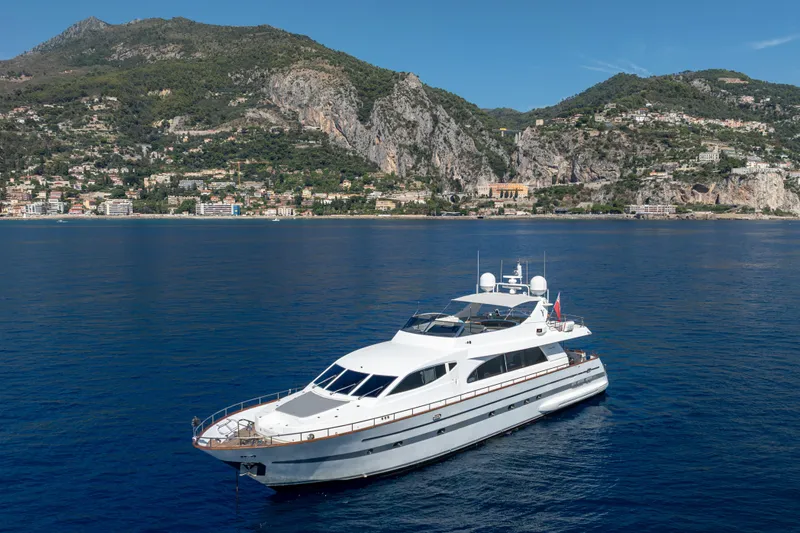  Yacht Photos Pics Luxury Falcon Yachts 86, 1999 model, cruising near scenic coastal mountains.