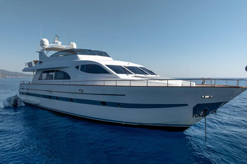  Yacht Photos Pics Luxurious 1999 Falcon Yachts 86 model cruising on calm blue waters.