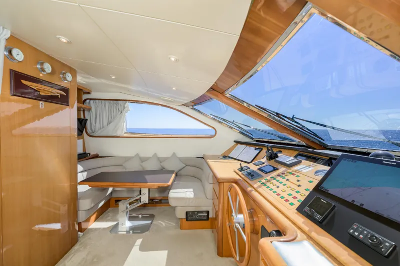  Yacht Photos Pics Luxurious interior of 1999 Falcon Yachts 86, featuring helm and seating area with ocean view.