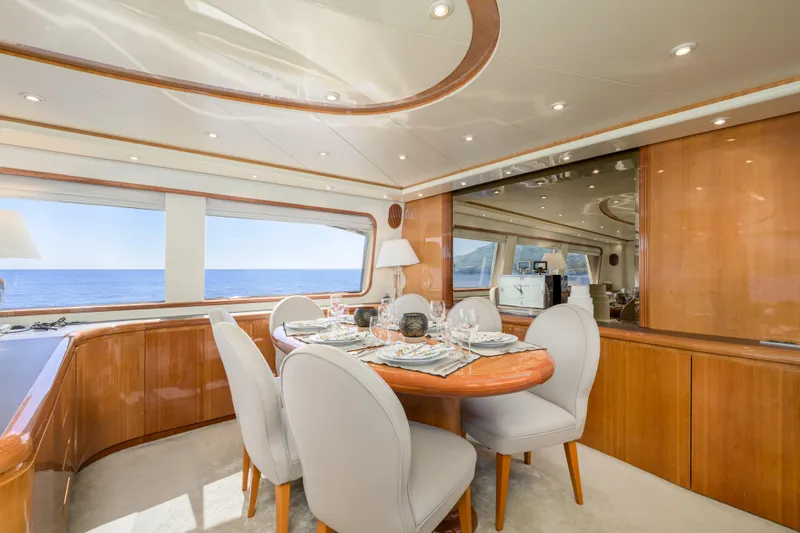  Yacht Photos Pics Luxurious dining area on a 1999 Falcon Yachts 86, featuring elegant wood finishes and ocean views.