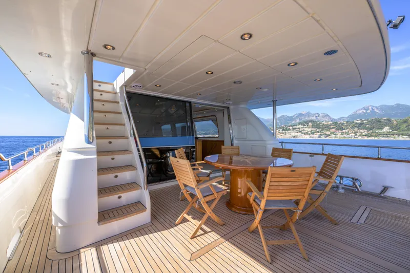  Yacht Photos Pics Luxurious 1999 Falcon Yachts 86 deck with seating, ocean view, and elegant design.