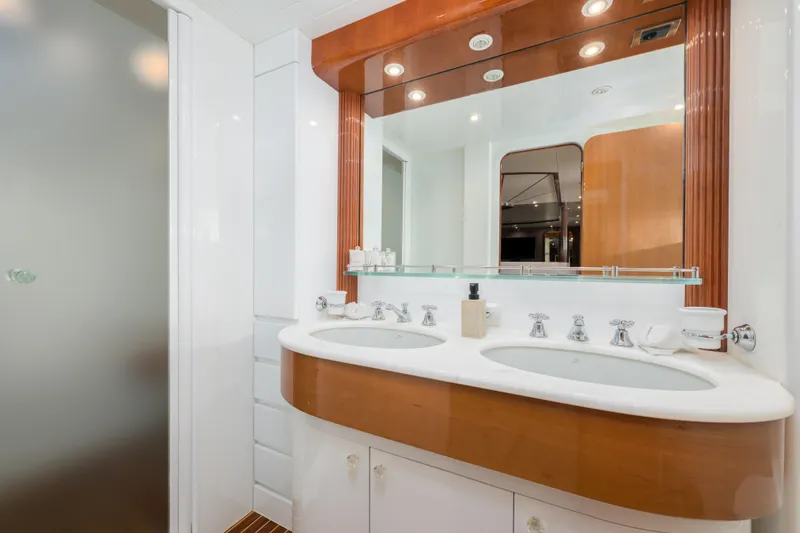  Yacht Photos Pics Luxurious bathroom on 1999 Falcon Yachts 86, featuring dual sinks and elegant wood accents.