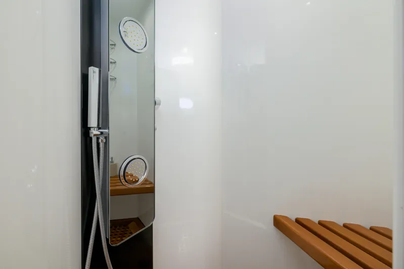  Yacht Photos Pics Shower area in 1999 Falcon Yachts 86, featuring modern fixtures and wooden bench.