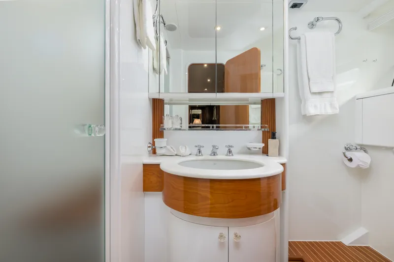  Yacht Photos Pics Luxurious bathroom in 1999 Falcon Yachts 86, featuring elegant fixtures and wood accents.