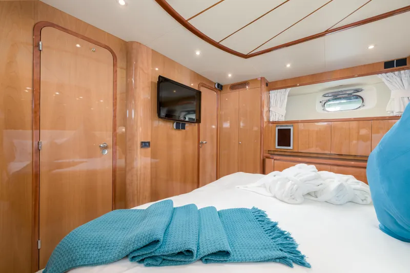  Yacht Photos Pics Luxurious cabin interior of 1999 Falcon Yachts 86, featuring wood paneling and modern amenities.