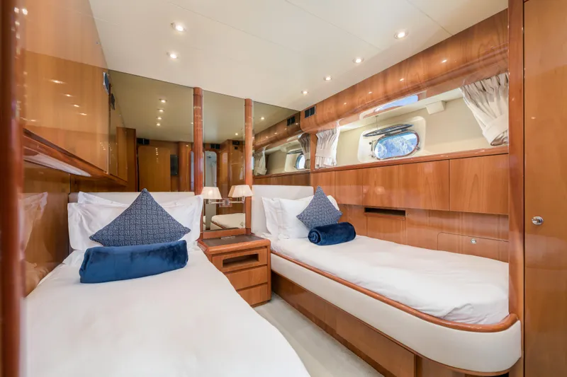  Yacht Photos Pics Luxurious twin cabin interior of 1999 Falcon Yachts 86, featuring elegant wood finishes.