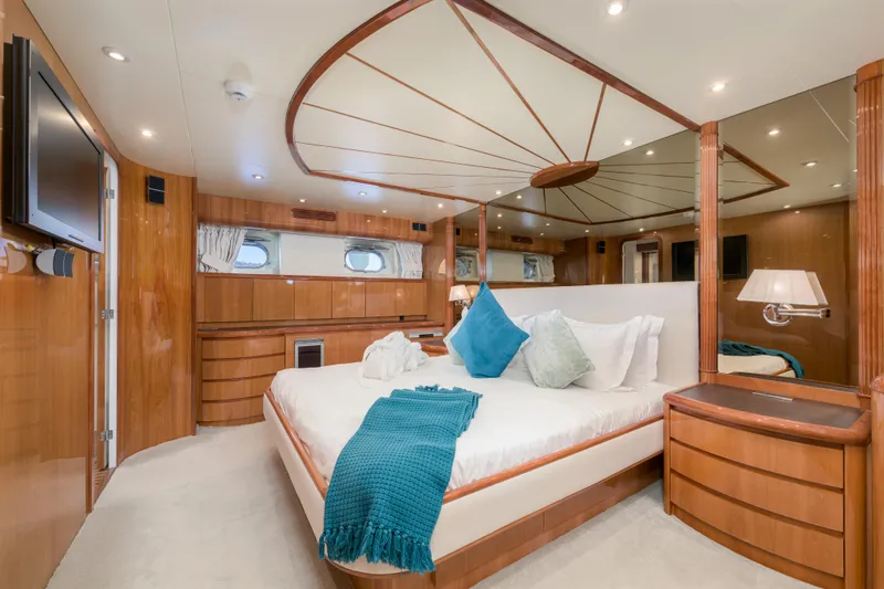  Yacht Photos Pics Luxurious 1999 Falcon Yachts 86 bedroom with elegant wood finish and plush bedding.